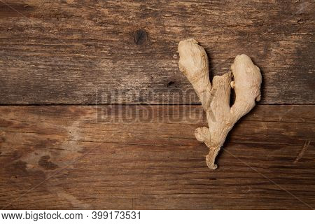Close Up Of Fresh Ginger Root On Wooden Table
