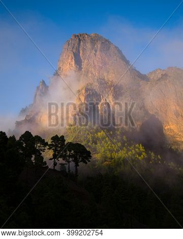 Top Of A Sunlit Mountain With Clouds