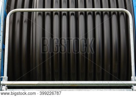 Irrigating With Hose Reel Irrigator. Rolled Up Of Black Rubber Hose, Industrial Detail.
