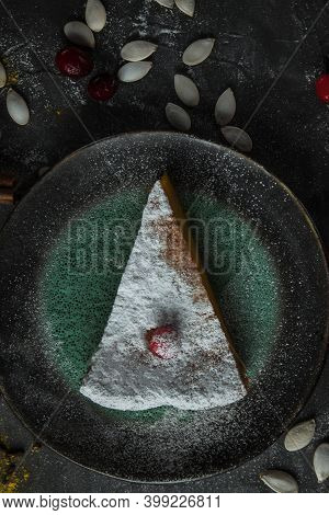 Beautiful Piece Of Pumpkin Pie On A Beautiful Plate With Berries. Nearby Pumpkin Seeds On A Stone Ta