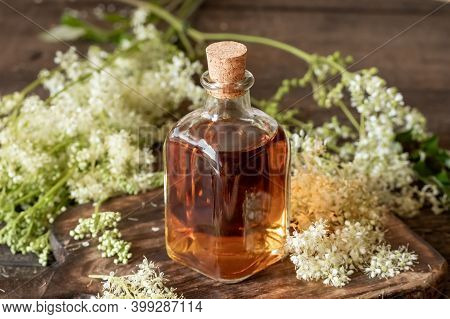Homemade Meadowsweet Tincture With Fresh Blooming Plant On A Table