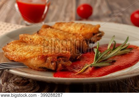 Buffolo Wings Close-up With Tomato Sauce And Tomatoes