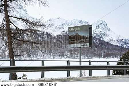 Val Bregaglia valley , Switzerland - January, 2016:  entrance to alpine valley Val Bregaglia with welcome information billboard,  canton of Graubunden.
