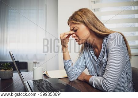 Young Woman Is Working From Home. She Is Having Headache.