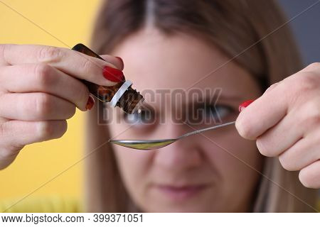 Woman Dripping Drops From Medicine Bottle Closeup. Liquid Forms Of Drugs Concept