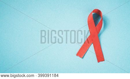 Red Ribbon On Grunge Blue Paper, Top View,  Hiv Awareness Concept, World Hypertension Day, World Aid