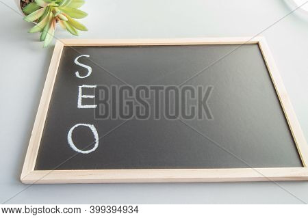 Hand-sketched Seo Concept In White Chalk On A Black Board.