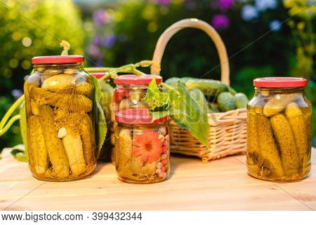 Pickled cucumbers in a jar. Autumn harvesting. Pickled and salted vegetables. Preservation for the winter. Summer country hobby.
