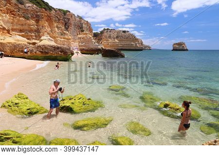 Algarve, Portugal - May 31, 2018: Beachgoers Visit Marinha Beach In Algarve Region, Portugal. Coasta