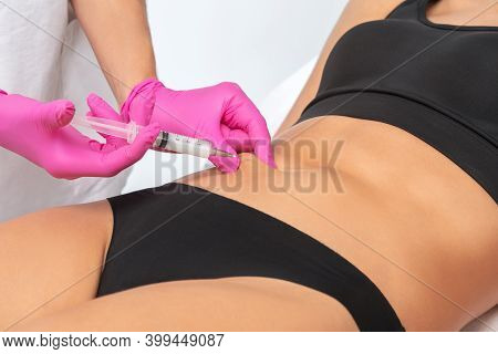 A Doctor Of Aesthetic Cosmetology Makes Lipolytic Injections To Burn Body Fat On A Woman’s Stomach A