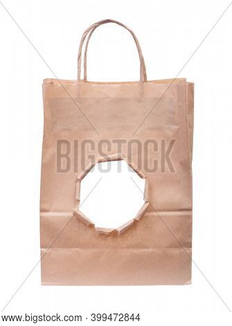 Paper bag with a torn hole isolated over white background