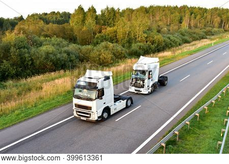 Heavy Recovery Truck Tows A Semitrailer Truck On Highway. Emergency Rescue Wrecker Tow Truck Coach H