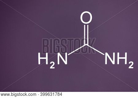 The Formula Of Urea Carbamide Is Written In White Paint On A Cement Wall Of Purple Color. Place For 