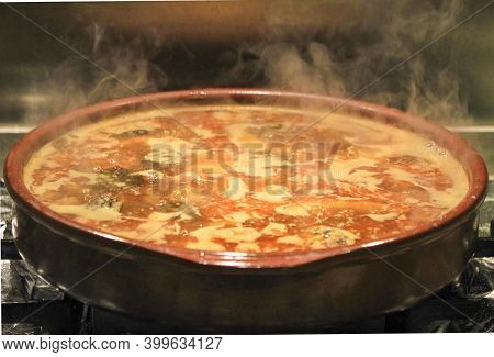 Boiling Broth With Rabbit Meat And Sausages In A Clay Pot To Do A Spanish Dish Called Costra