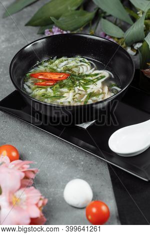 Bowl Of Chicken Noodle On Gray Concrete Background