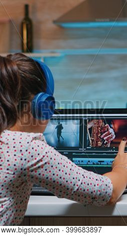 Video Editor Wearing Headset And Working From Home At Digital Project Sitting In The Kitchen. Videog
