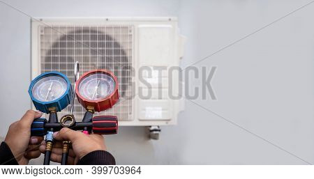 Air Repair Mechanic Using Measuring Equipment For Filling Industrial Factory Air Conditioners And Ch