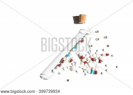 Flat Lay Of Pills On White Background. Piles With Capsule And Test Tube. Pill Bottle Spilling Pills 