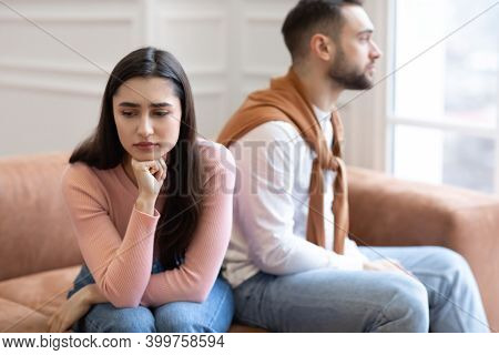 Marriage Crisis. Offended Arab Couple Not Talking After Quarrel Sitting On Different Sides Of Sofa A