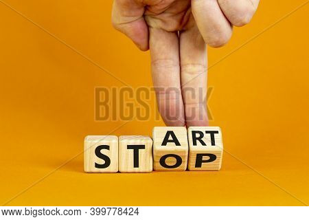 Business And Stop Or Start Concept.male Hand Flips A Wooden Cube And Changes The Word 'stop' To 'sta