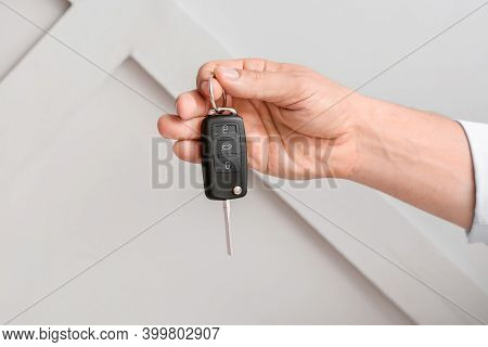 Male Hand With Car Key On Light Background