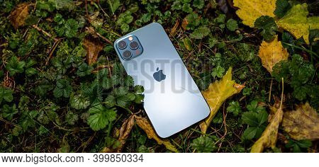 Paris, France - Nov 11, 2020: Male Hand Holding Against Juniper Tree Background New Apple Computers 