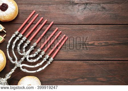 Hanukkah Traditional Menorah, Candles, Doughnuts, Dreidels With Letters He, Pe, Nun, Gimel On Wooden