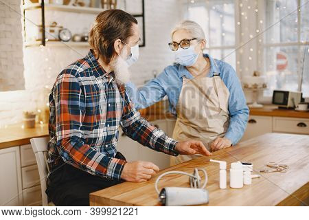Senior Woman And Man At Home Meassure Blood Pressure