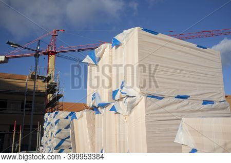 Extruded Polystyrene Foam Packs At Construction Site. Cranes At Bottom