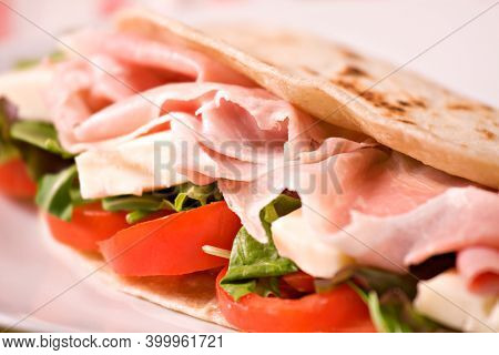 Traditional Italian Piadina With Ham, Cheese, Tomato And Salad.