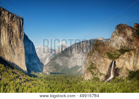 Small clouds gather over the snow capped Half Dome in Yosemite Valley, Yosemite National Park, California, USA