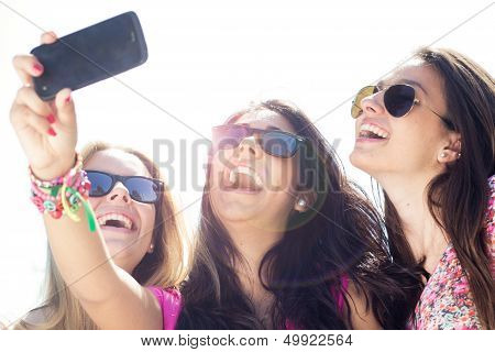 Three Friends Taking Photos With A Smartphone