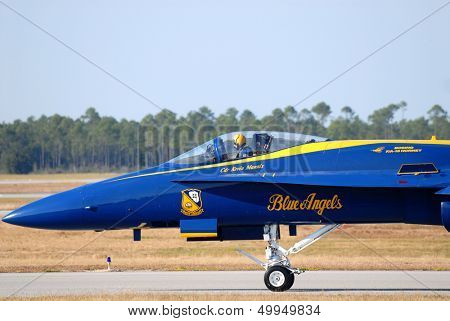 A closeup of the pilot in the cockpit of a Navy Blue Angel FA-18 Hornet awaiting takeoff