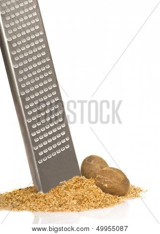 Freshly grated nutmeg with a micro plane grater on white