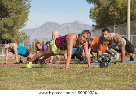 Group Doing Push-ups With Instructor