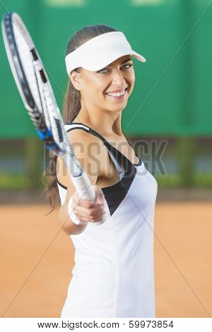 Woman Playing Tennis At Court And Smiling