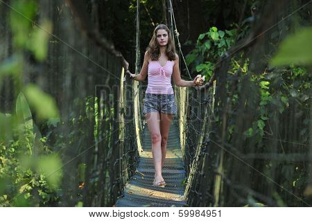 Sexy girl on the rope bridge