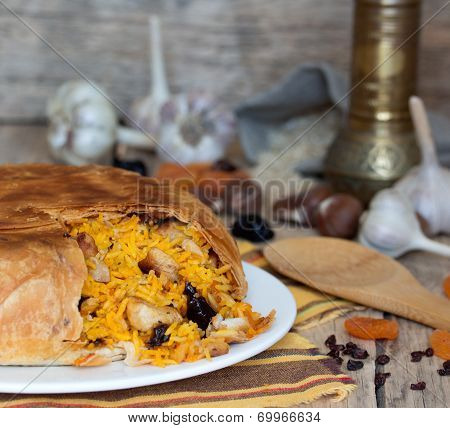 Pilaf in tortillas with dried fruits, garlic and burberry