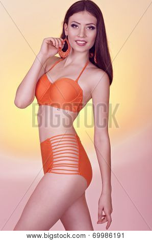 Woman in swimming suit on colorful background