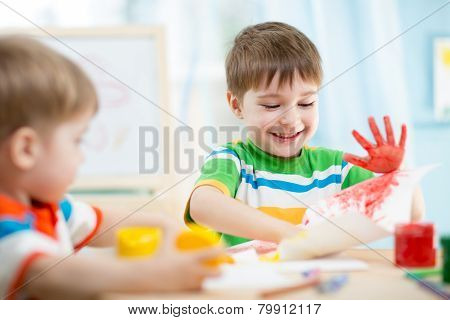 smiling kids playing and painting
