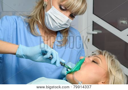 dentist with patient, installation of rubber dam