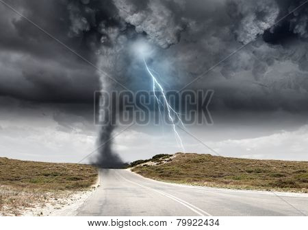 Powerful tornado and lightning above countryside road