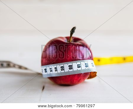 Diet Concept With Red Apple And Measuring Tape
