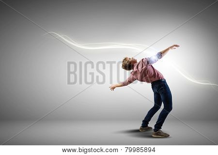 Young guy in casual evading from light rays