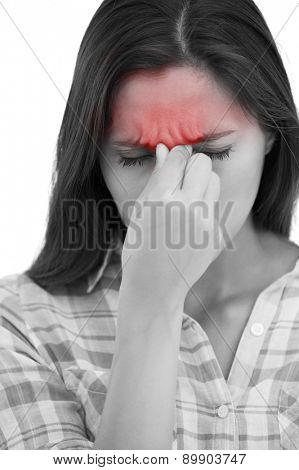 Brunette wincing with headache pain on white background