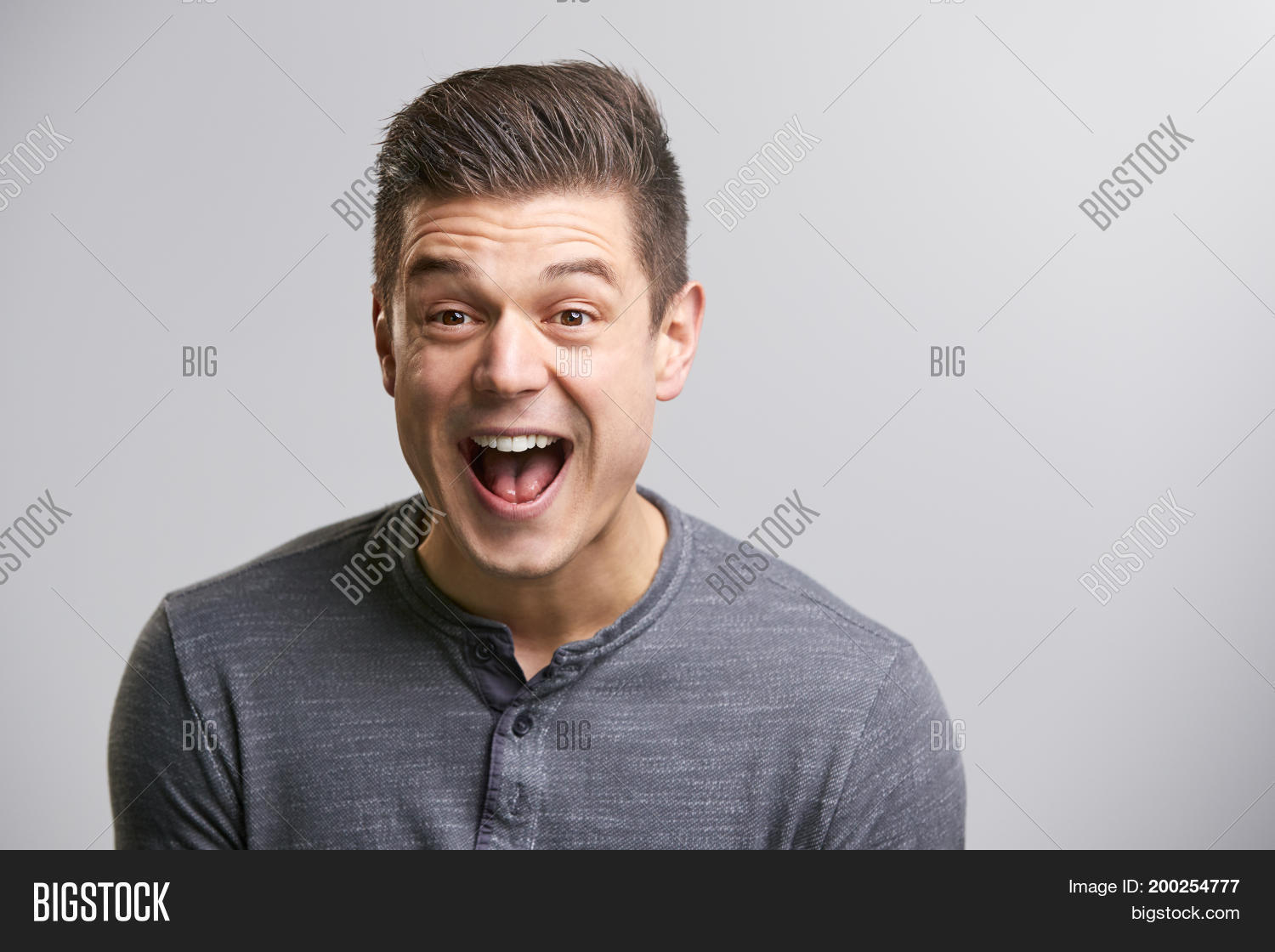 portrait of a laughing young white man looking to camera