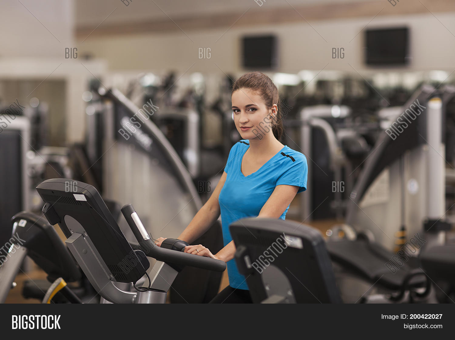 young fit woman using a bicycle in a fitness center cardio.