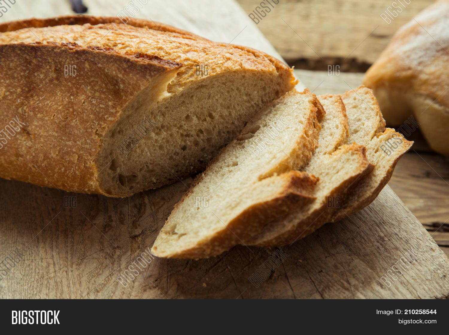 top view of sliced wholegrain bread on a wooden table.