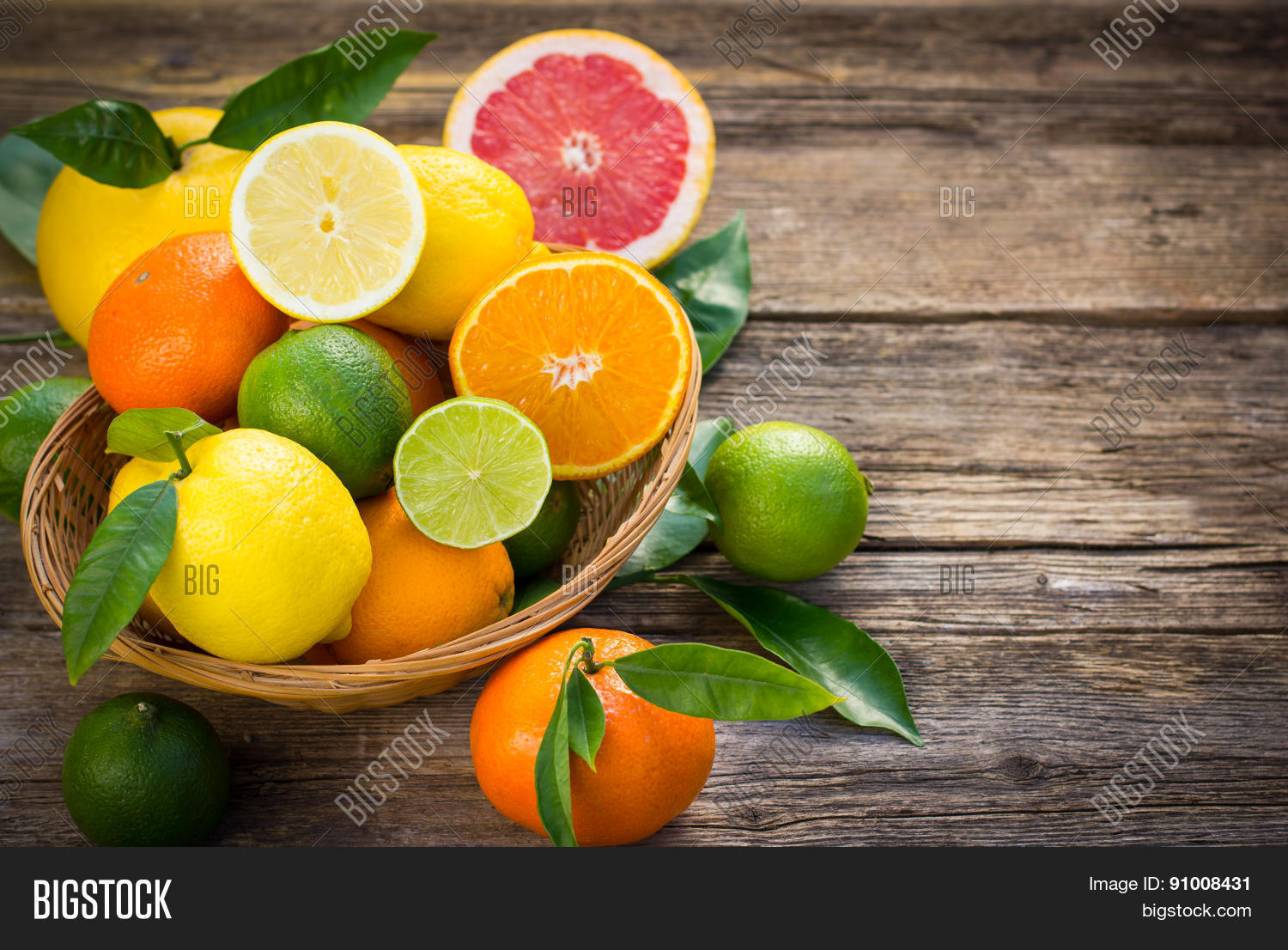 fresh and juicy citrus fruits in the basket on the rustic table