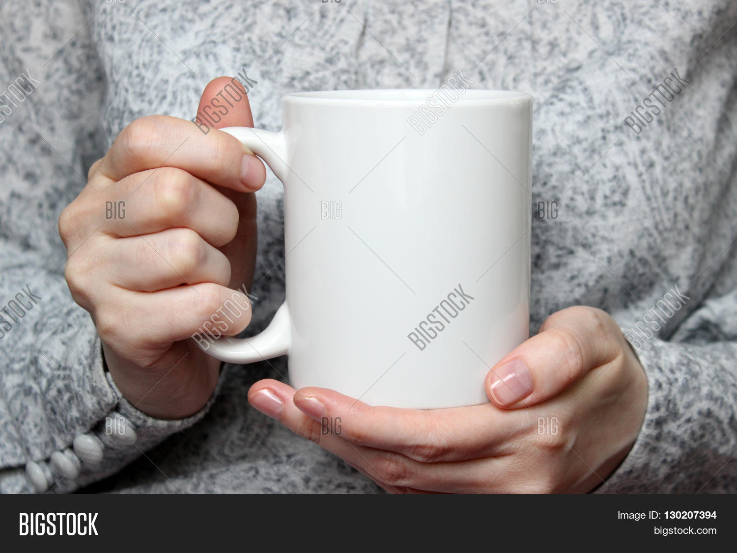 girl is holding white cup in hands. white mug in womans hands.